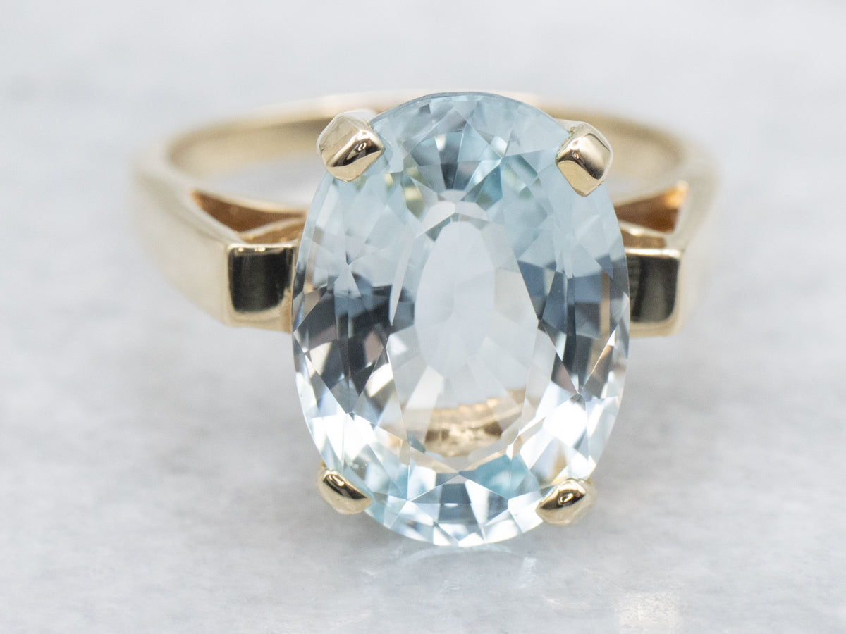 Minimalist Blue Topaz and Gold Solitaire Ring