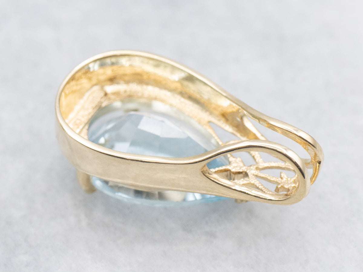 Pear Cut Blue Topaz and Gold Pendant