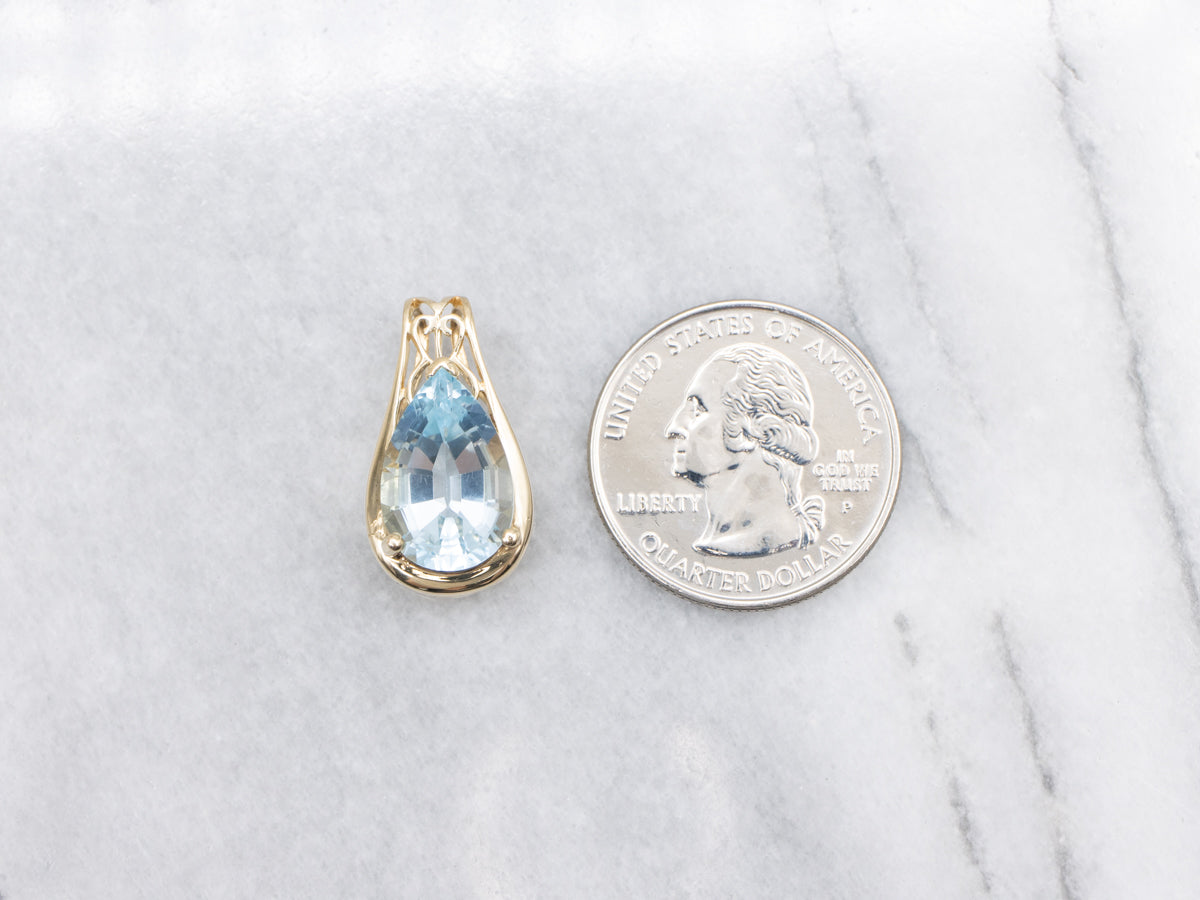 Pear Cut Blue Topaz and Gold Pendant