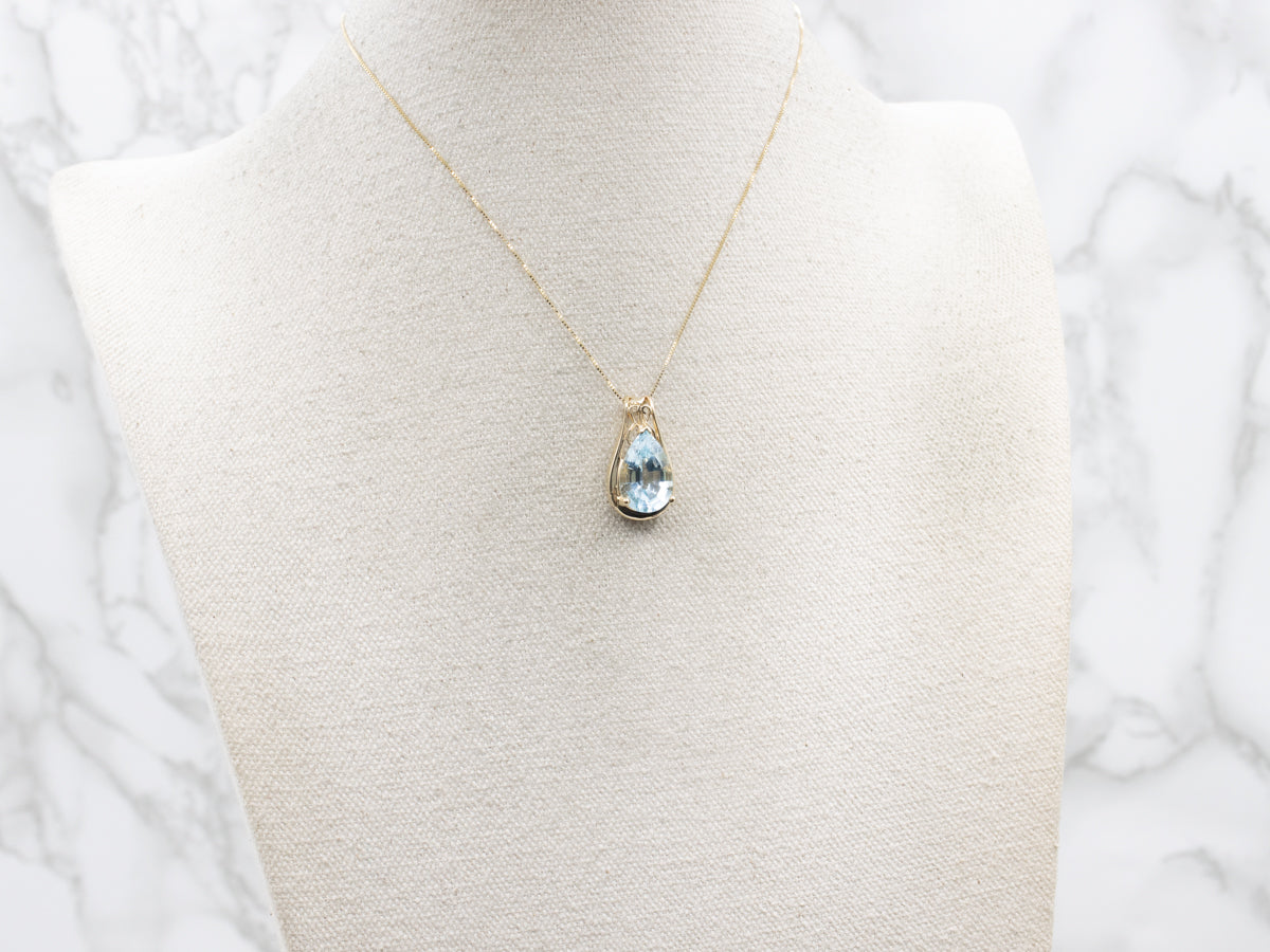 Pear Cut Blue Topaz and Gold Pendant