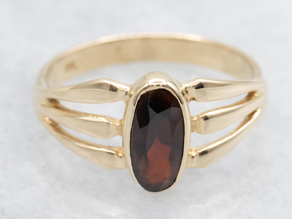 Bezel Set Garnet and Split Shank Gold Ring