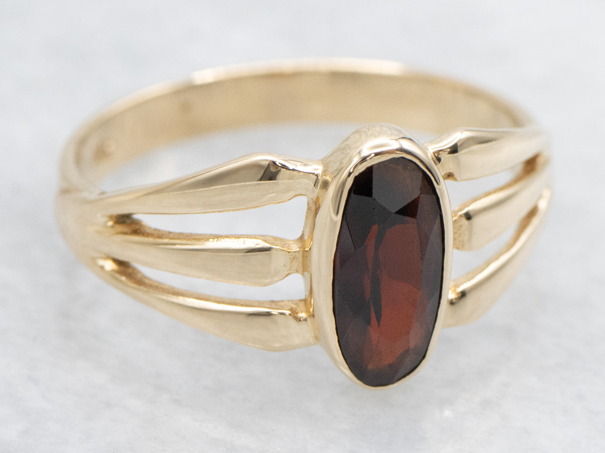 Bezel Set Garnet and Split Shank Gold Ring