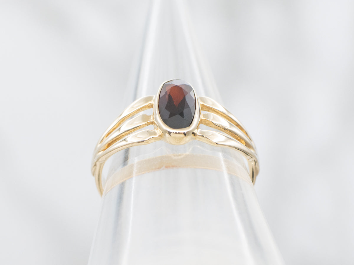 Bezel Set Garnet and Split Shank Gold Ring