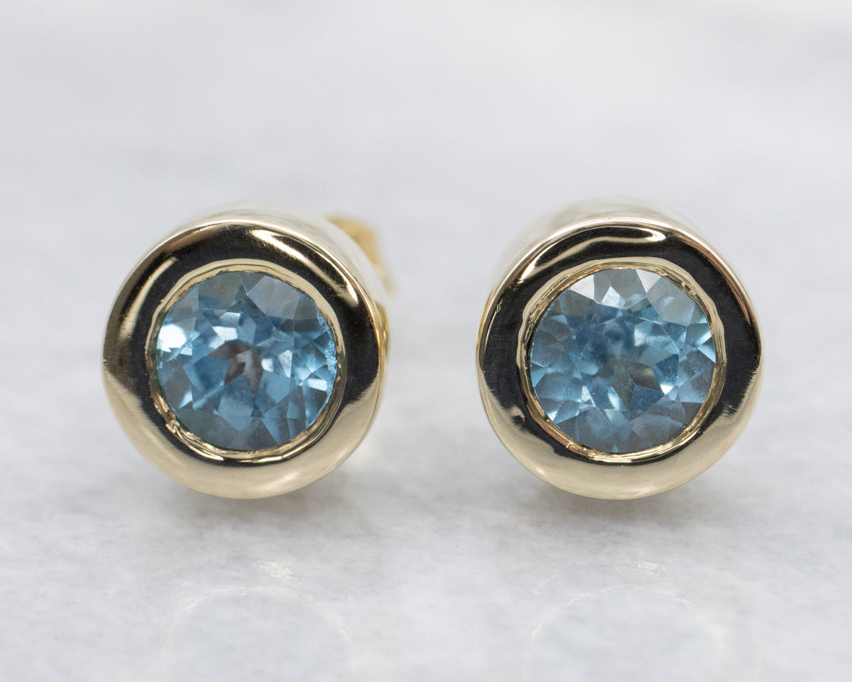 Bezel Set Blue Topaz Gold Stud Earrings