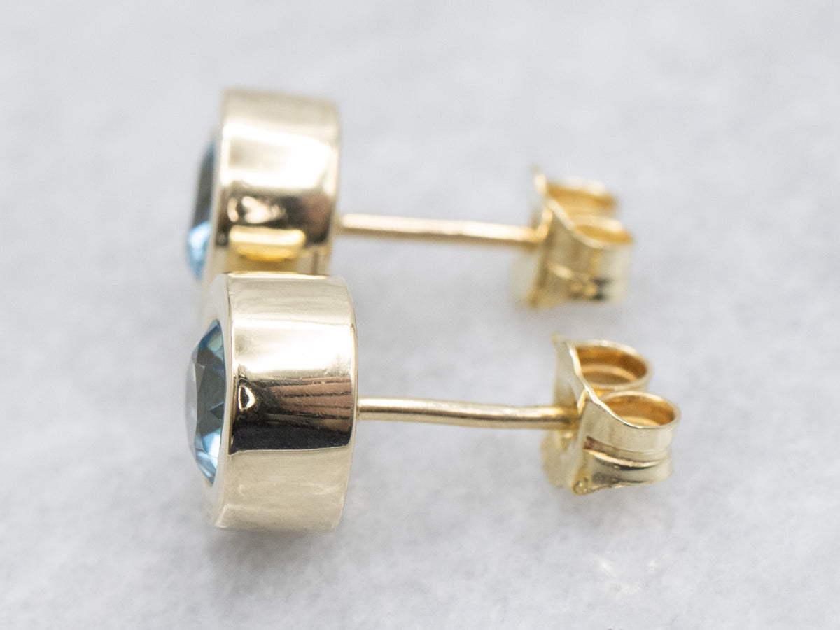 Bezel Set Blue Topaz Gold Stud Earrings