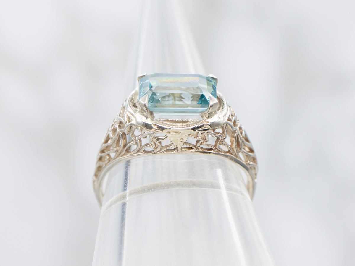 East to West Emerald Cut Blue Zircon Gold Filigree Ring