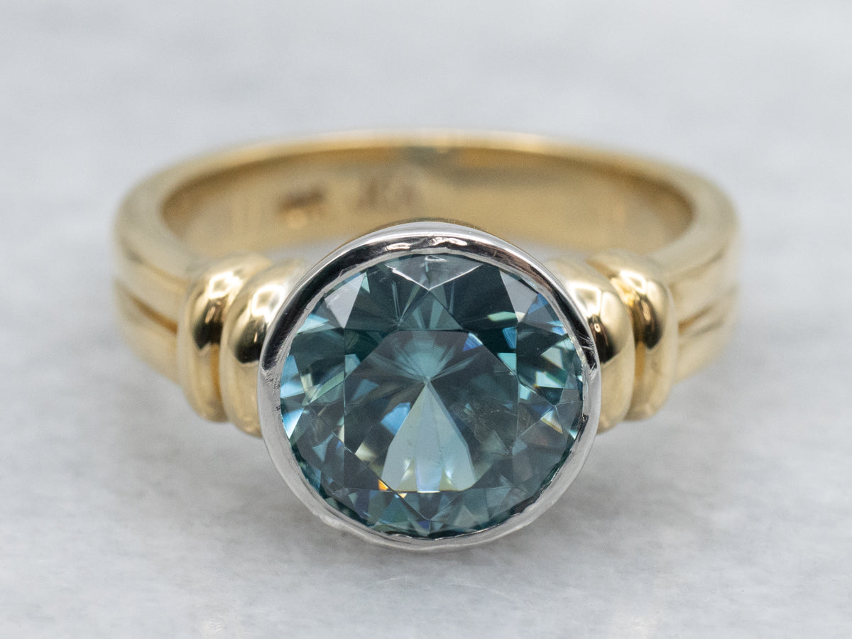 Modern Bezel-Set Platinum and Gold Blue Zircon Solitaire Ring