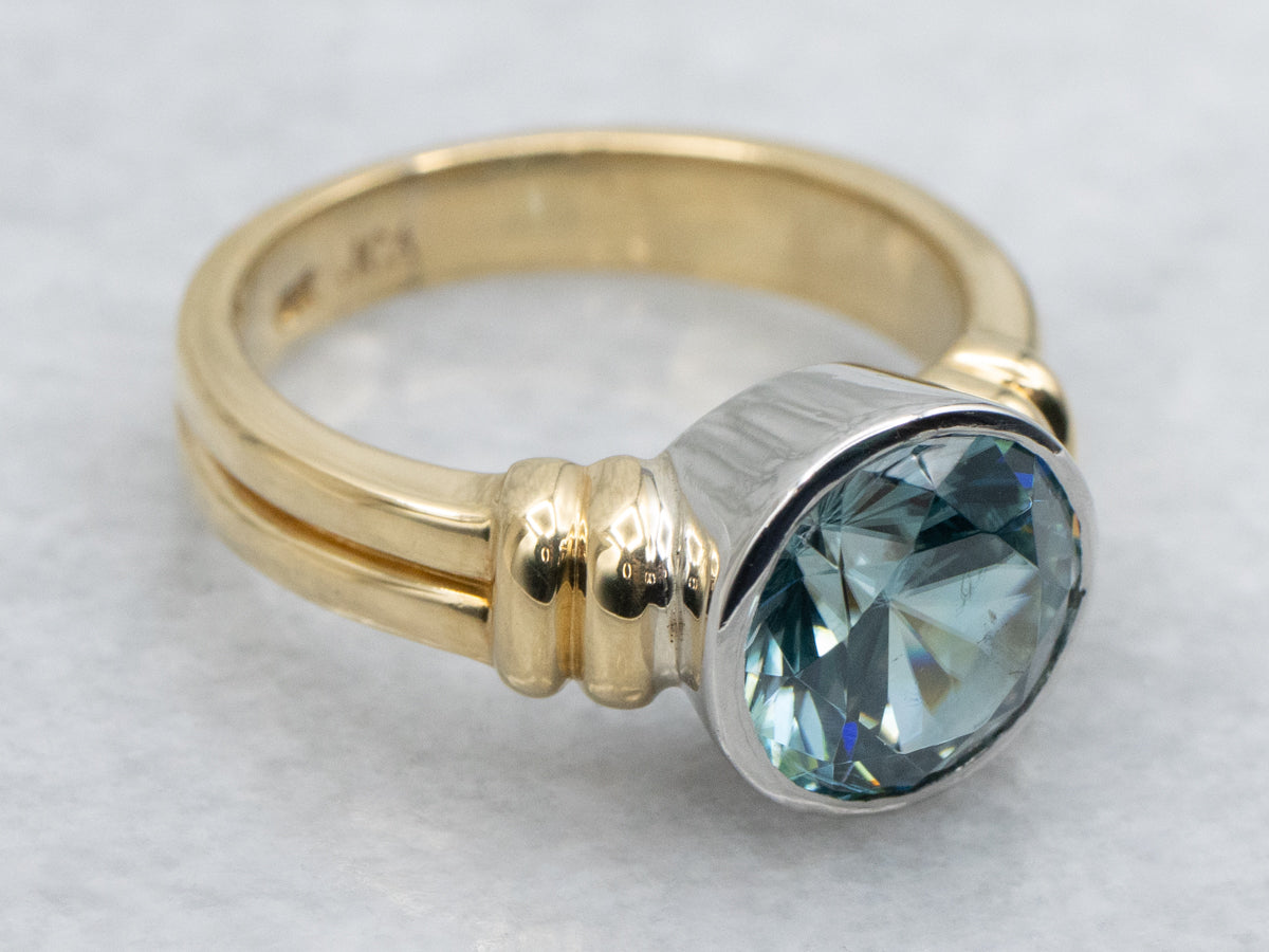 Modern Bezel-Set Platinum and Gold Blue Zircon Solitaire Ring