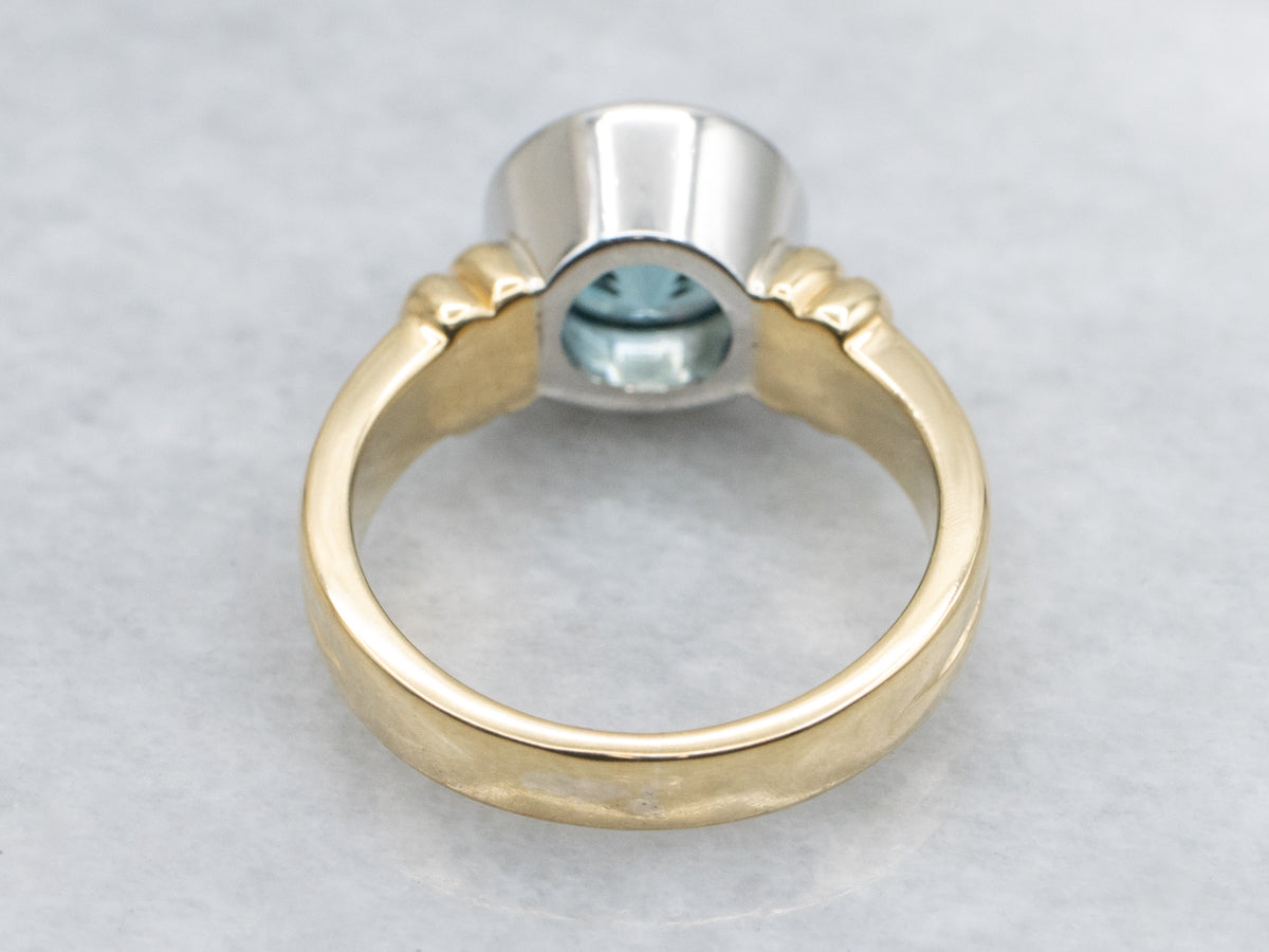 Modern Bezel-Set Platinum and Gold Blue Zircon Solitaire Ring