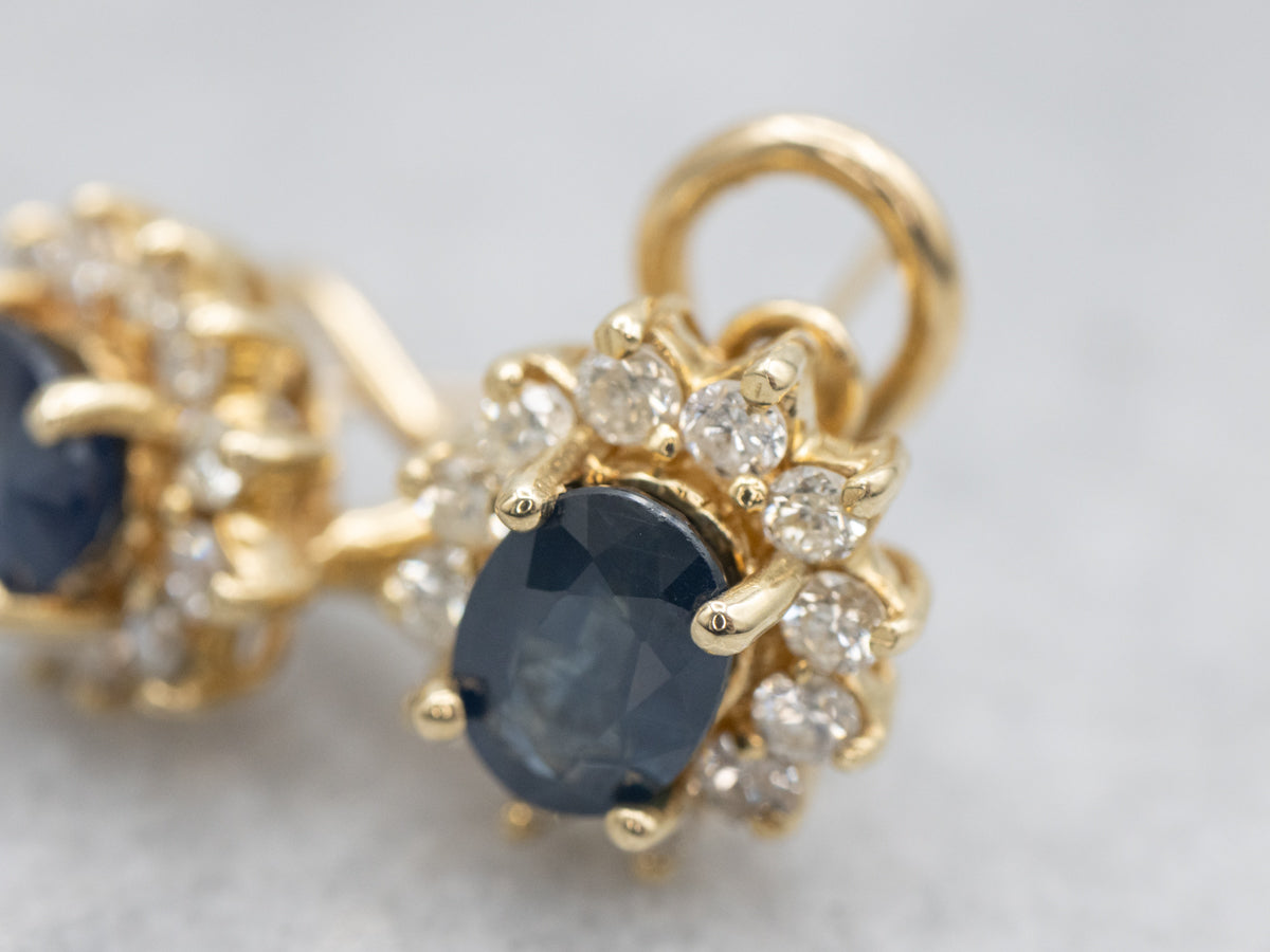 Navy Hued Sapphire and Diamond Halo Yellow Gold Earrings