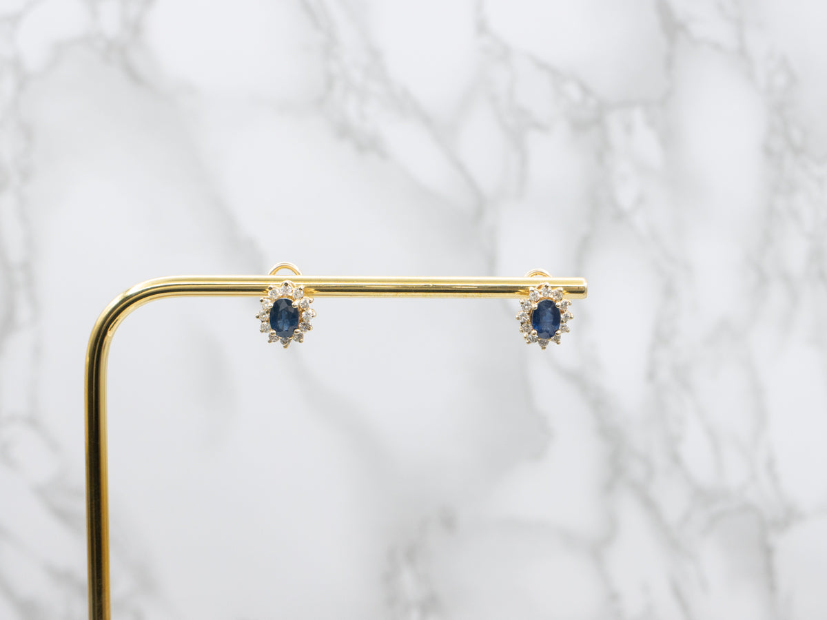 Navy Hued Sapphire and Diamond Halo Yellow Gold Earrings