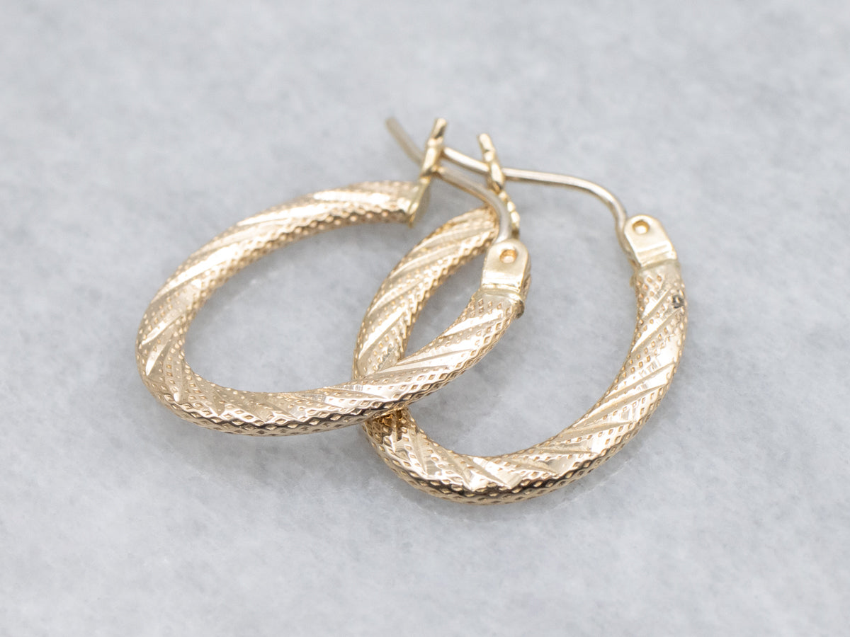 Textured Gold Twisting Oval-Shaped Hoop Earrings