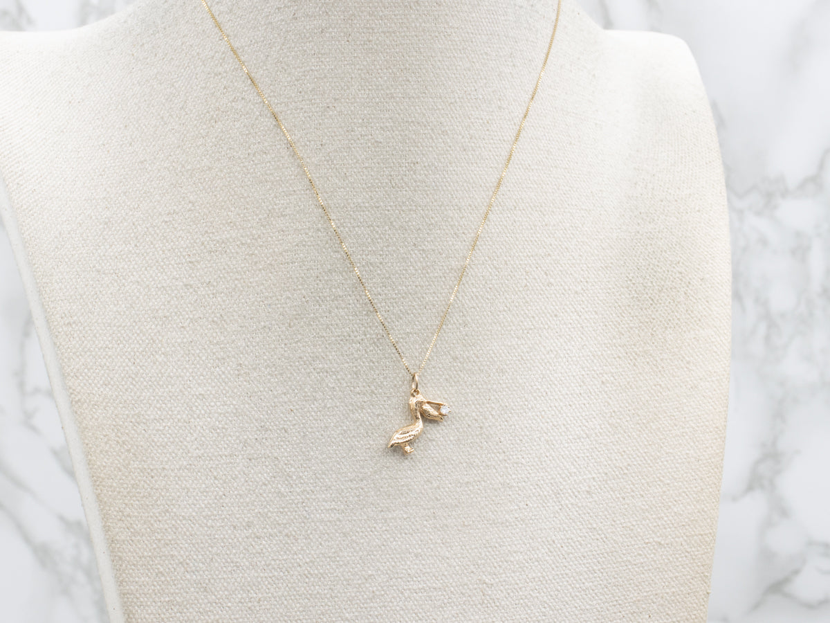 Yellow Gold Detailed Pelican Pendant with Diamond in Mouth