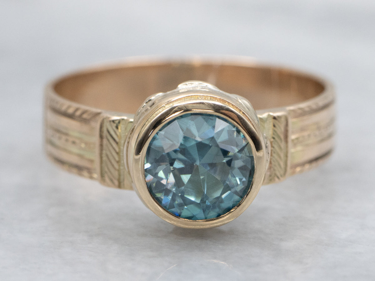 Newly Set Blue Zircon Solitaire in Antique Engraved Gold Setting