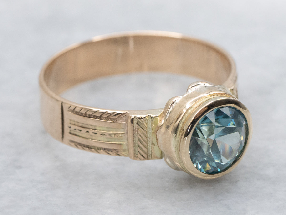 Newly Set Blue Zircon Solitaire in Antique Engraved Gold Setting