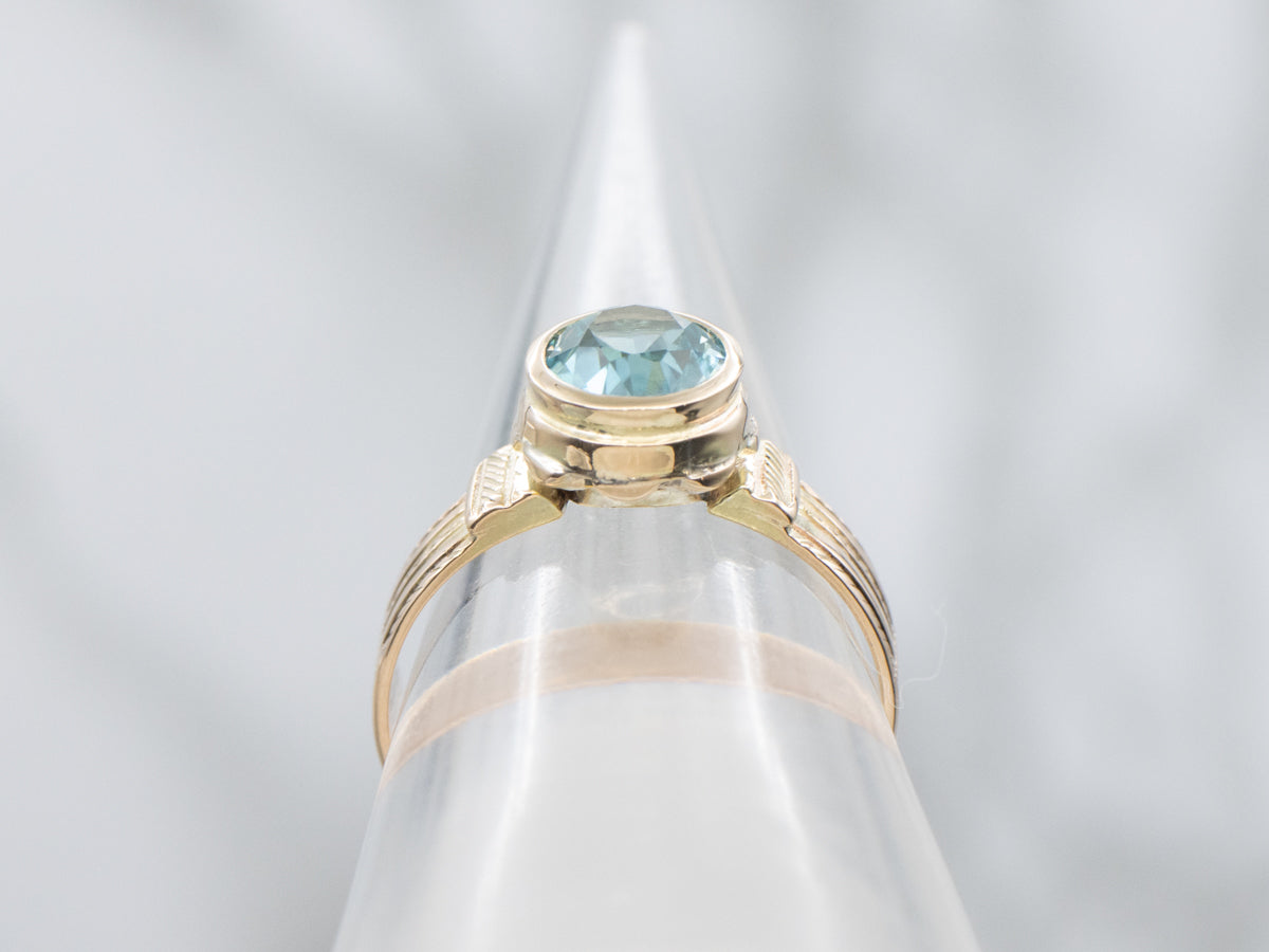 Newly Set Blue Zircon Solitaire in Antique Engraved Gold Setting