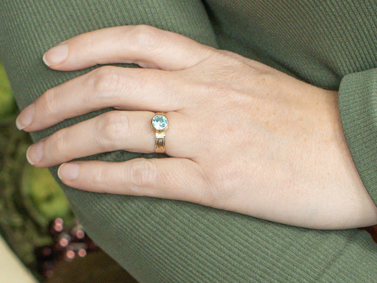 Newly Set Blue Zircon Solitaire in Antique Engraved Gold Setting