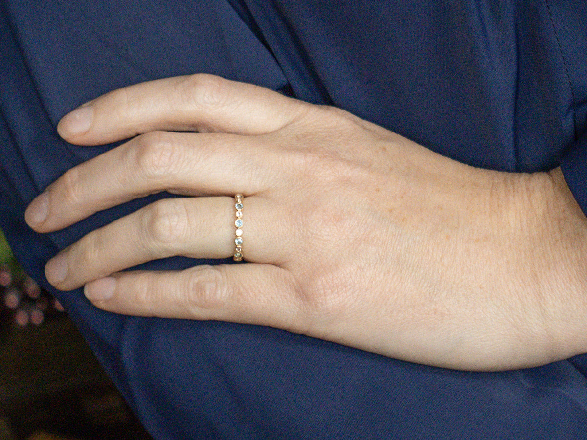 Bezel-Set Blue Topaz and White Sapphire Yellow Gold Eternity Band