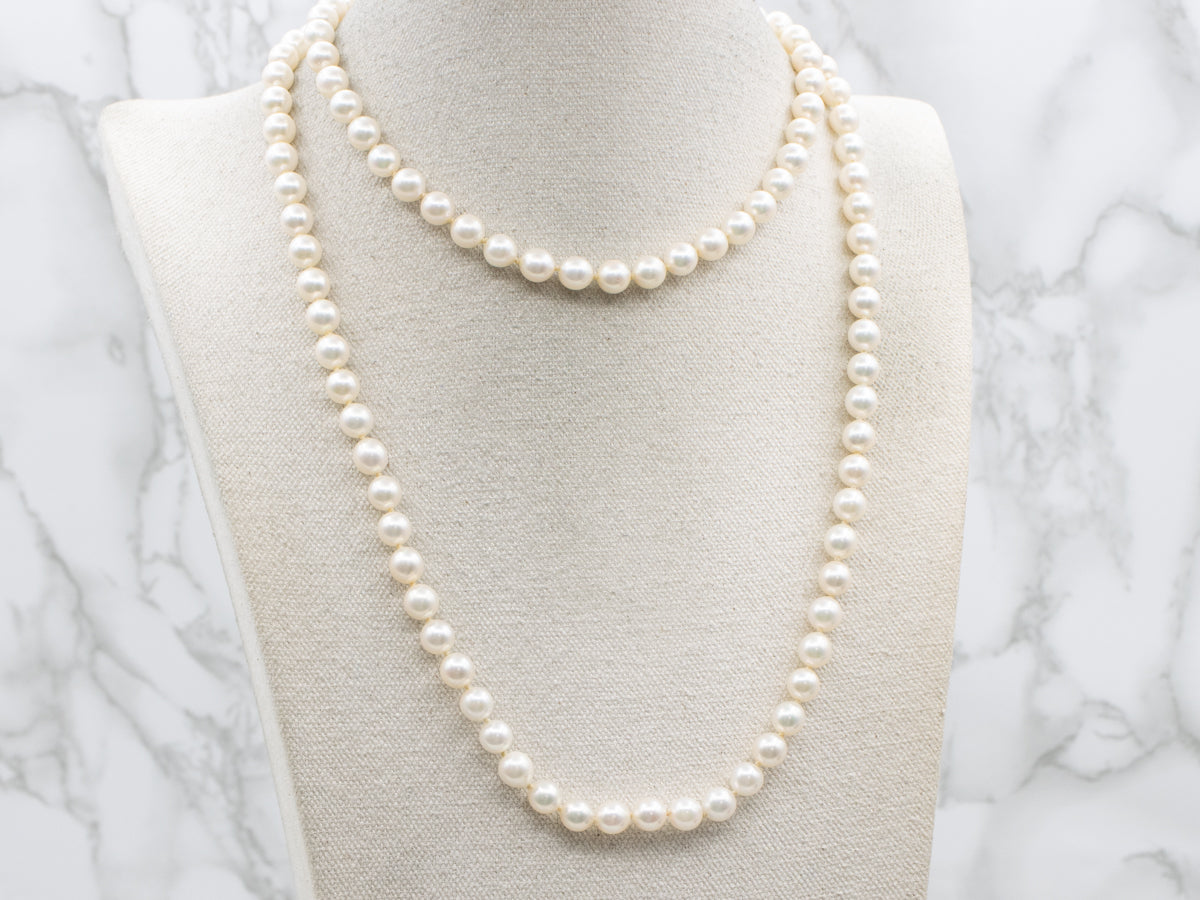 Long Pearl Strand Necklace with Gold Seashell Clasp