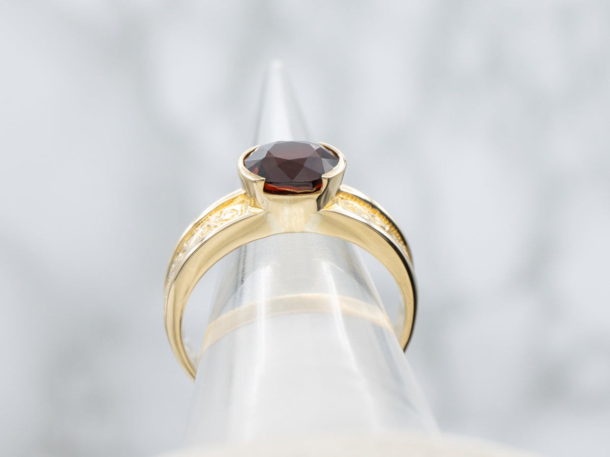 Men's East-to-West Set Garnet Scrolling Engraved Yellow Gold Solitaire Ring