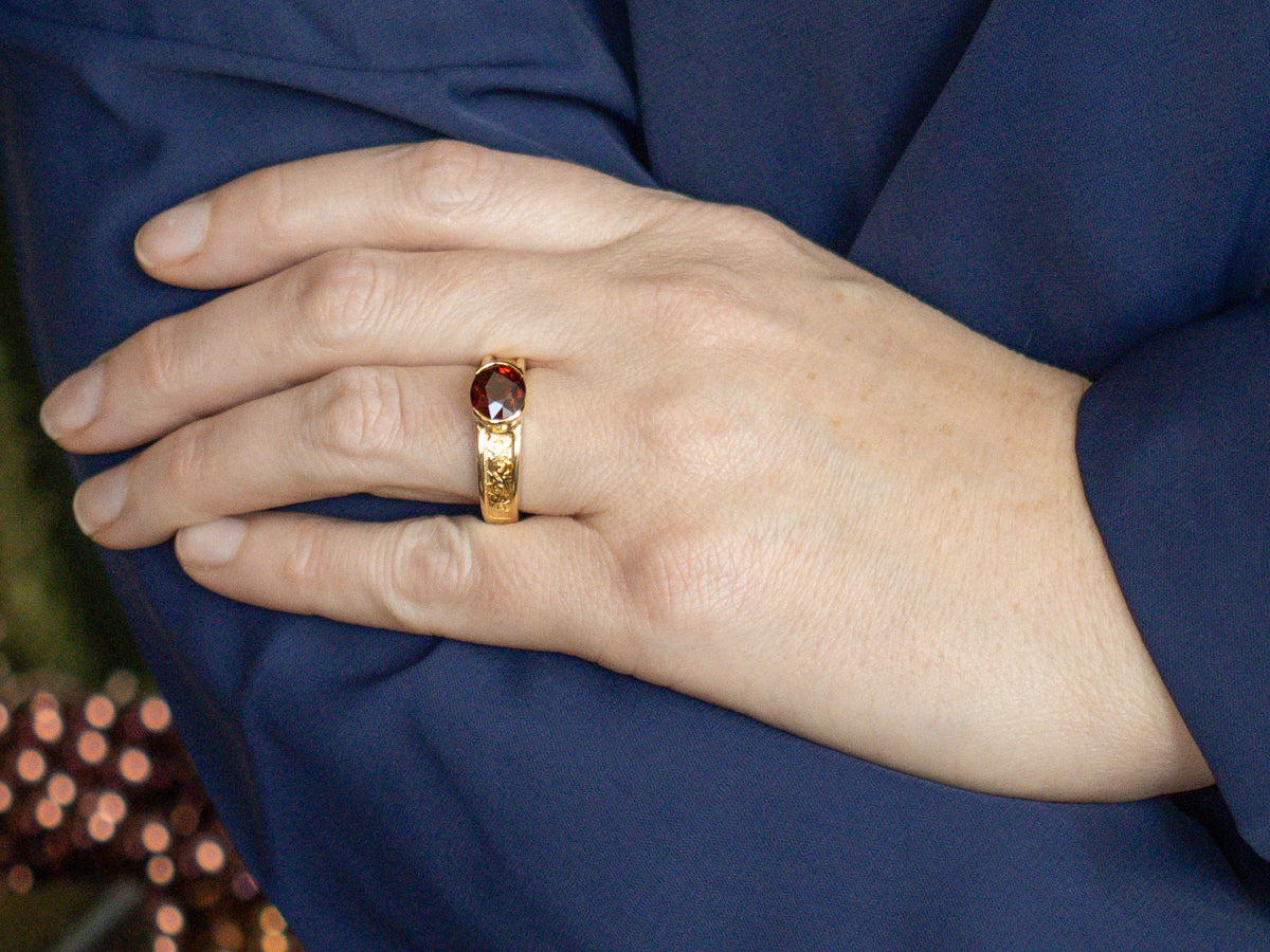 Men's East-to-West Set Garnet Scrolling Engraved Yellow Gold Solitaire Ring