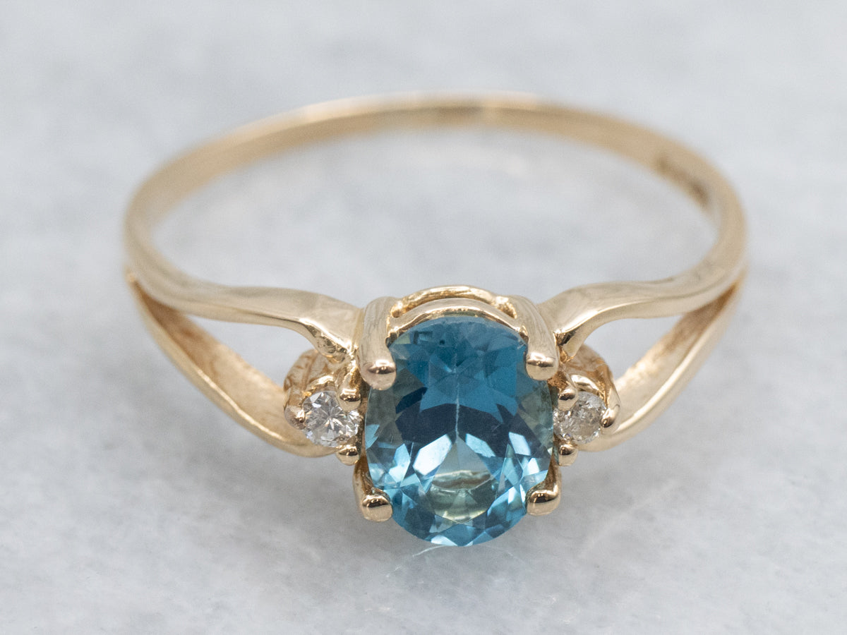 Oval-Cut Blue Topaz and Diamond Accent Yellow Gold Split Shank Ring