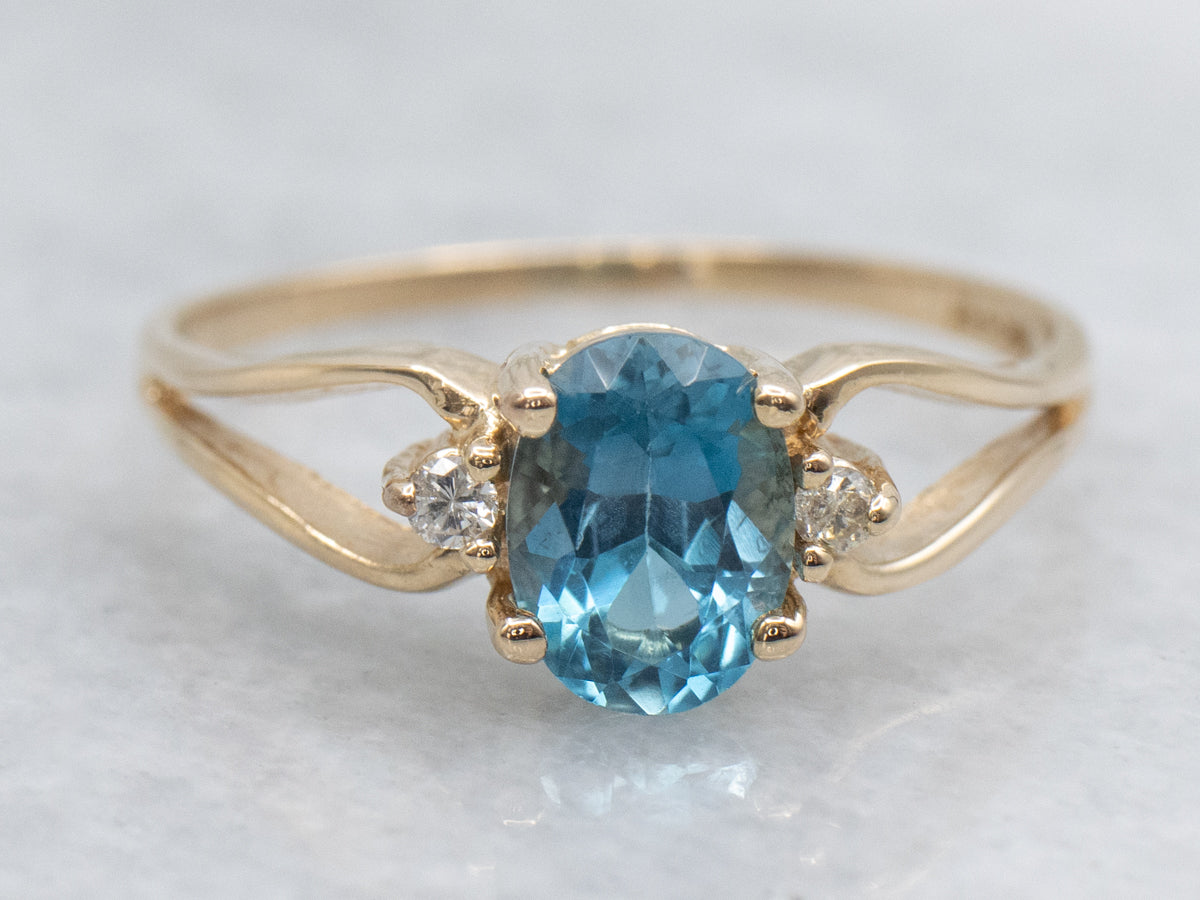 Oval-Cut Blue Topaz and Diamond Accent Yellow Gold Split Shank Ring