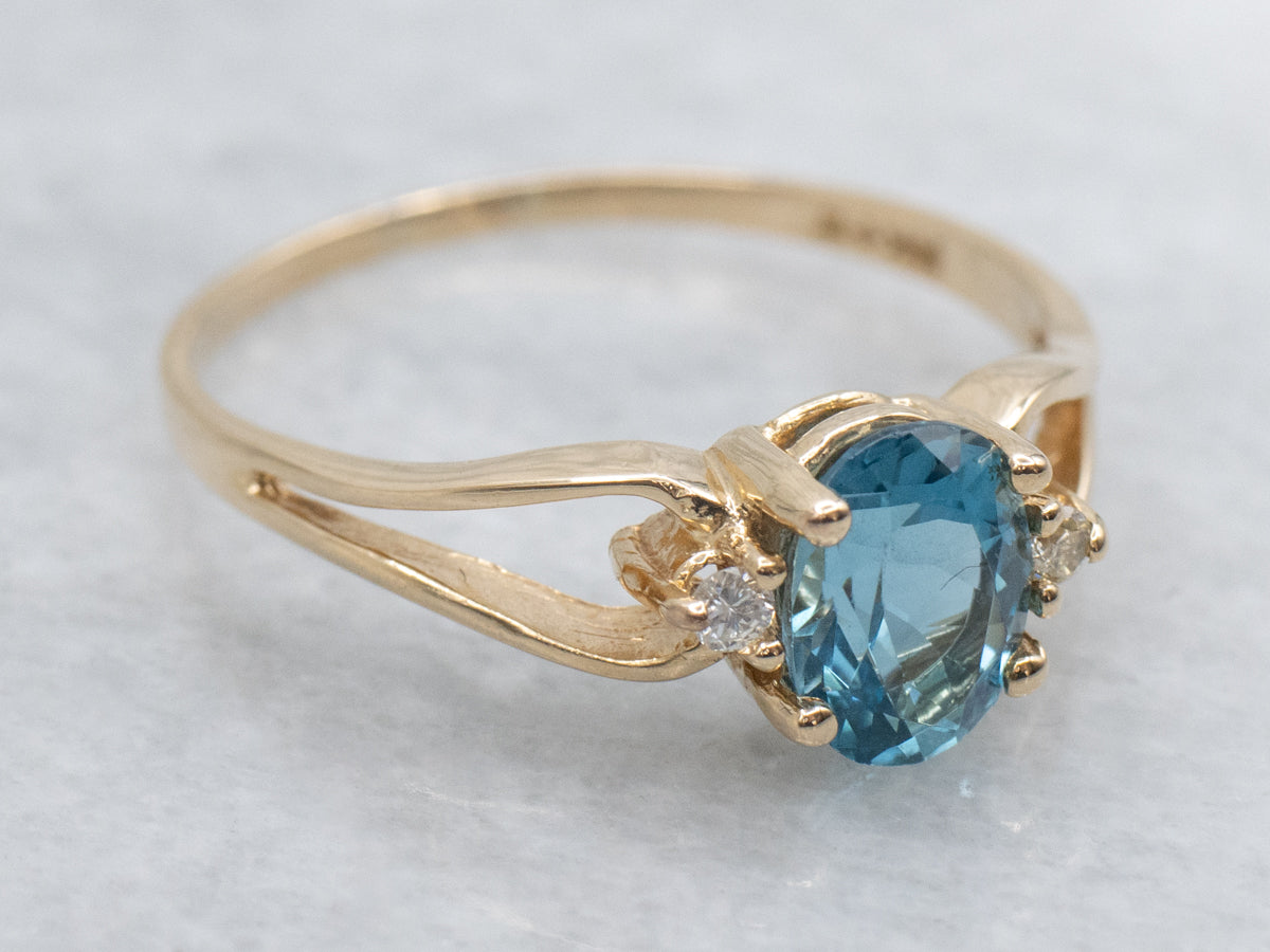 Oval-Cut Blue Topaz and Diamond Accent Yellow Gold Split Shank Ring