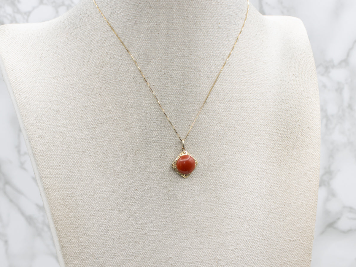 Coral Cabochon and Engraved Gold Floral Pendant