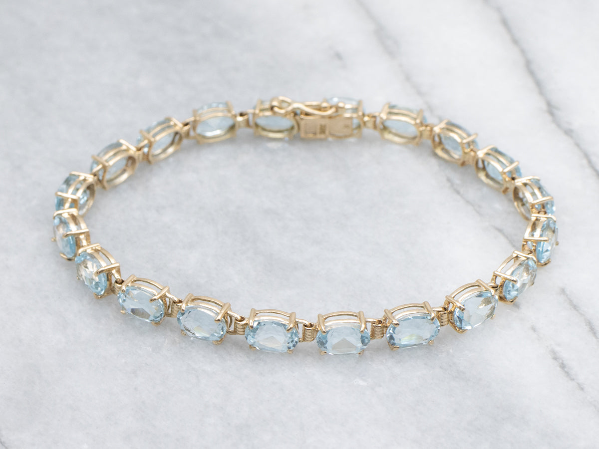 Oval-Cut Blue Topaz Yellow Gold Tennis Bracelet