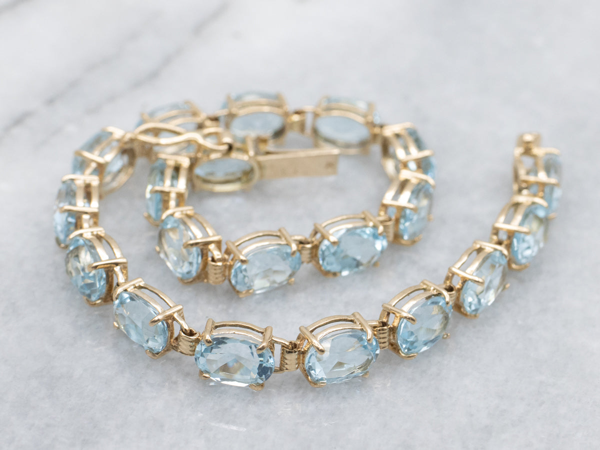 Oval-Cut Blue Topaz Yellow Gold Tennis Bracelet