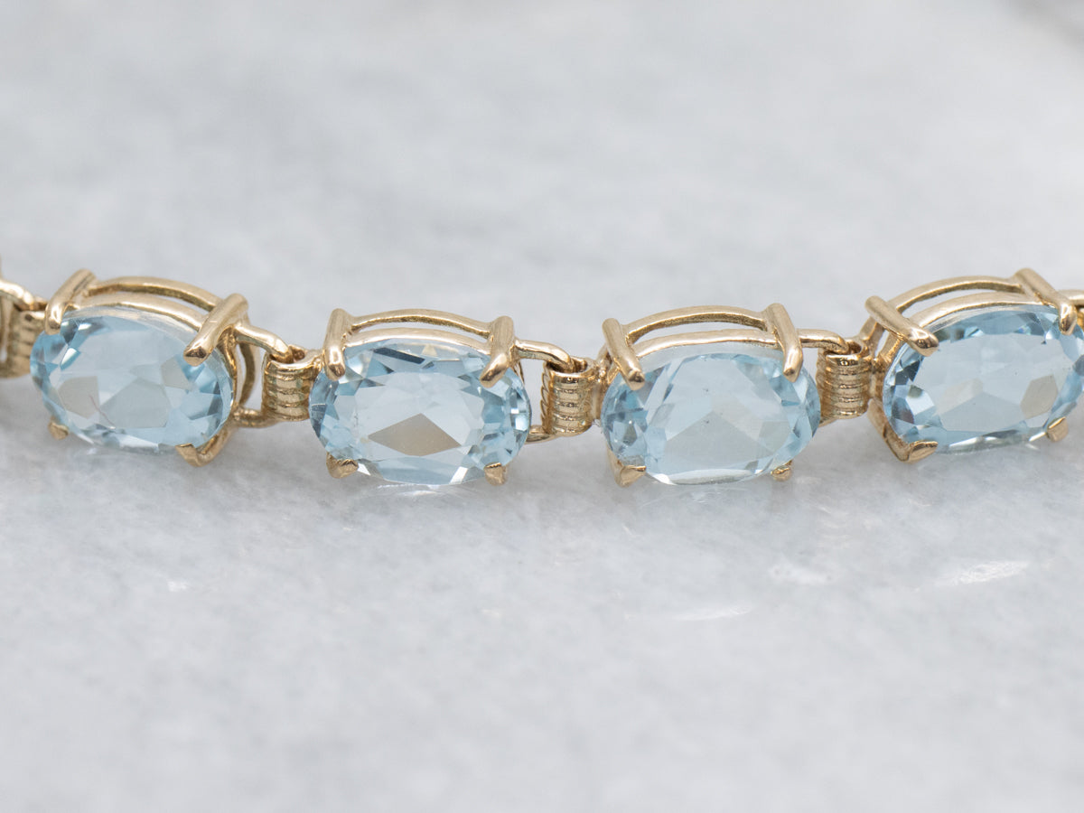 Oval-Cut Blue Topaz Yellow Gold Tennis Bracelet