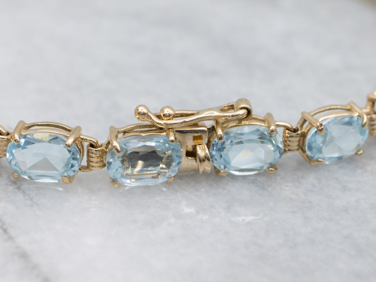 Oval-Cut Blue Topaz Yellow Gold Tennis Bracelet
