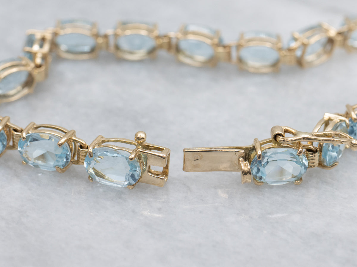 Oval-Cut Blue Topaz Yellow Gold Tennis Bracelet