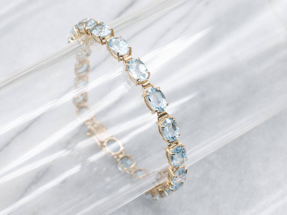 Oval-Cut Blue Topaz Yellow Gold Tennis Bracelet