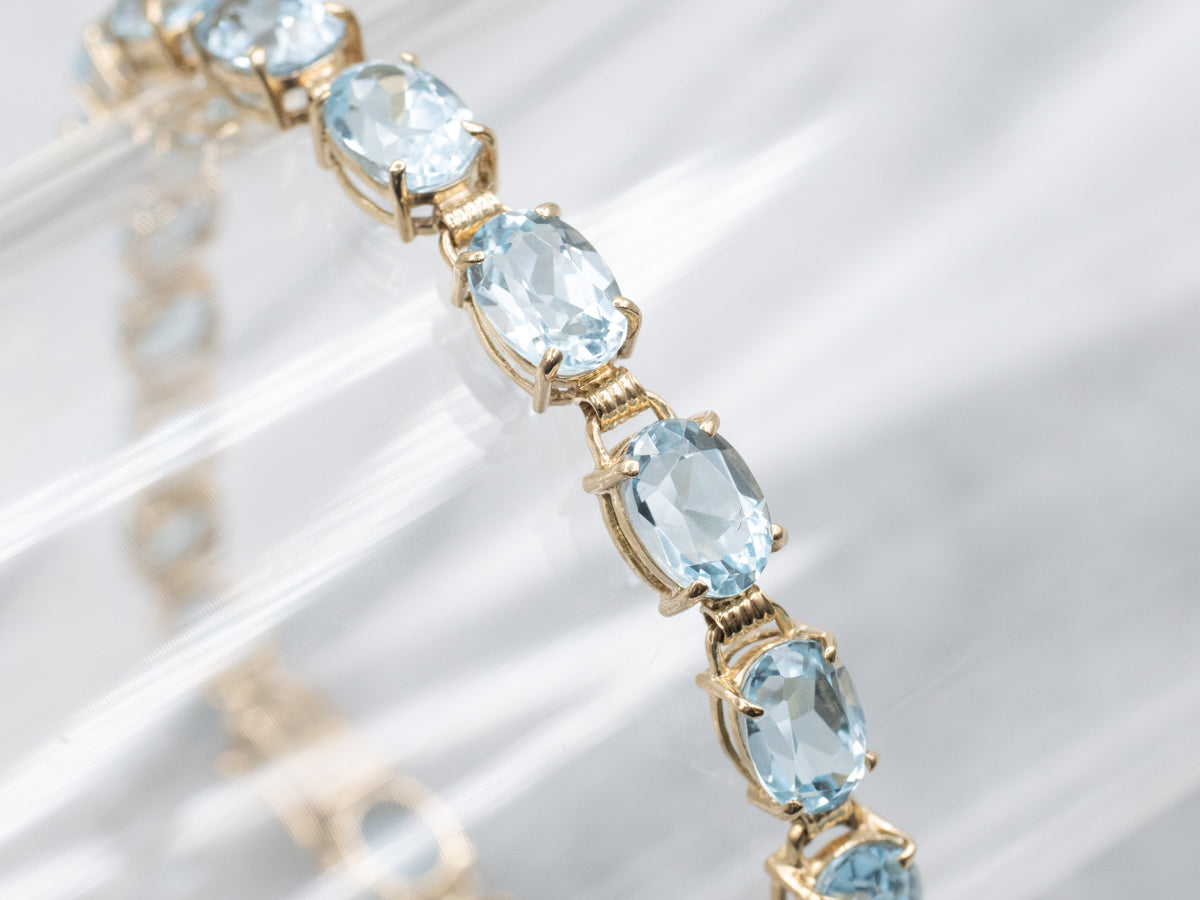 Oval-Cut Blue Topaz Yellow Gold Tennis Bracelet