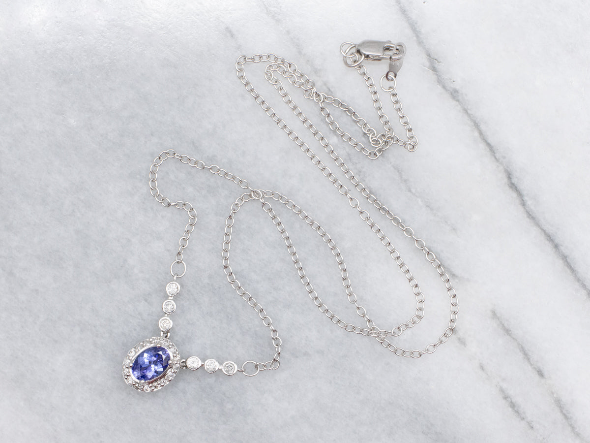 Modern Tanzanite and Diamond Halo Pendant Necklace