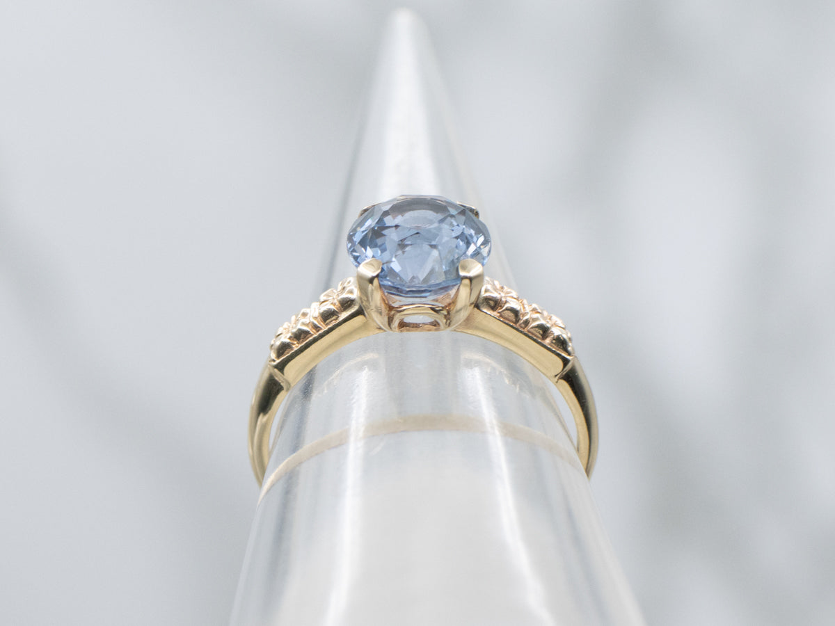 Indigo-Hued Spinel in Vintage Gold Floral Solitaire Setting