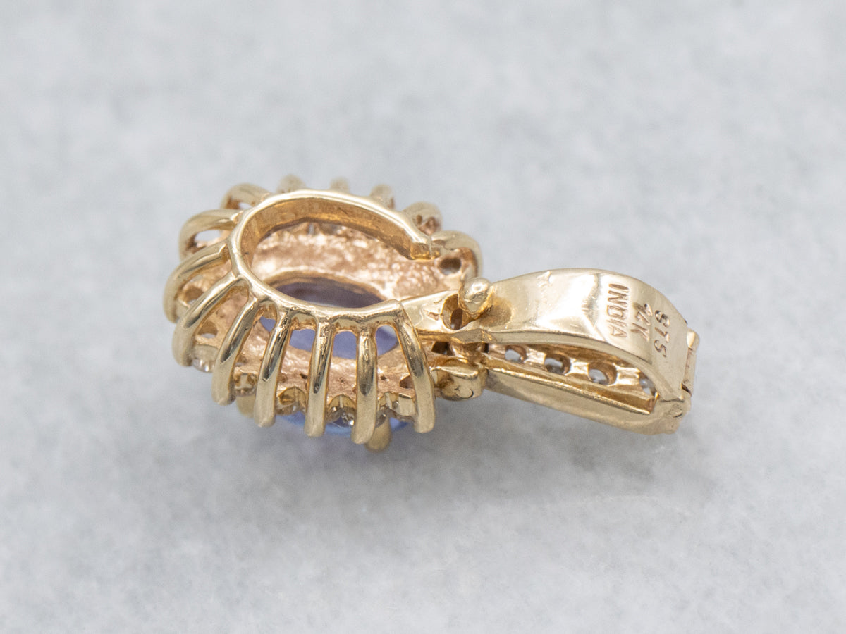 Modern Tanzanite and Diamond Halo Pendant