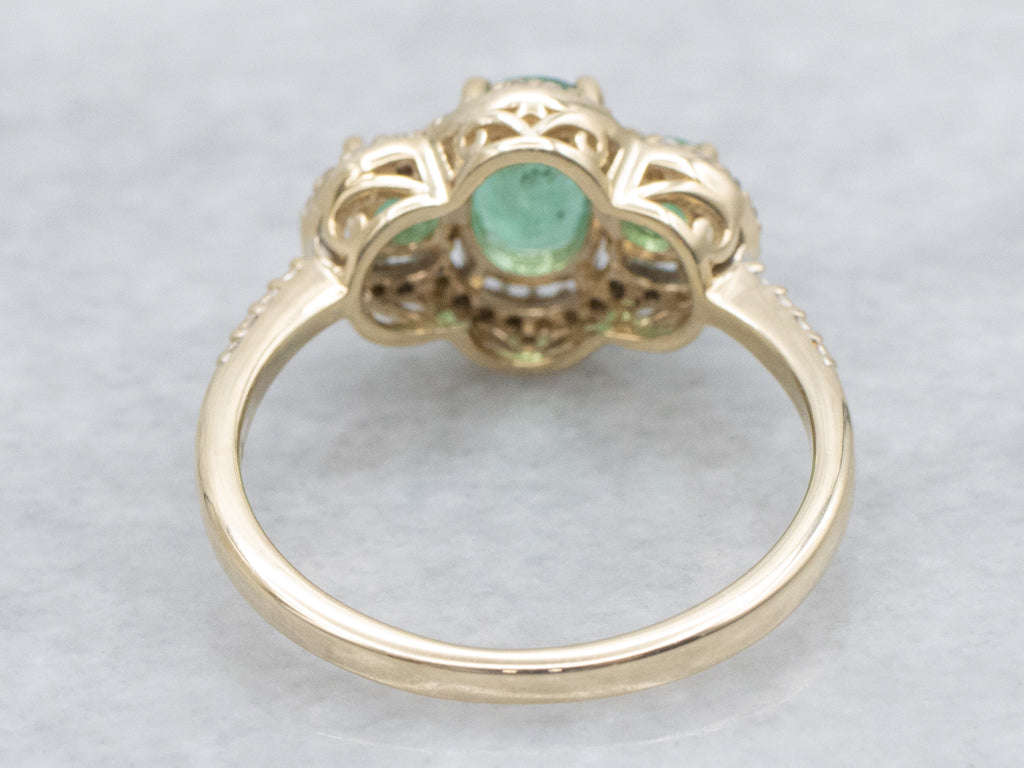 Vintage Gold Three-Stone Emerald and Diamond Halo Ring