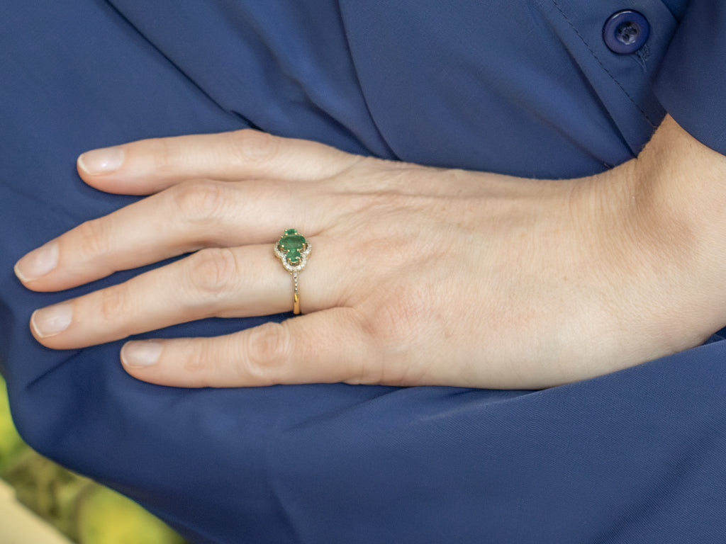 Vintage Gold Three-Stone Emerald and Diamond Halo Ring