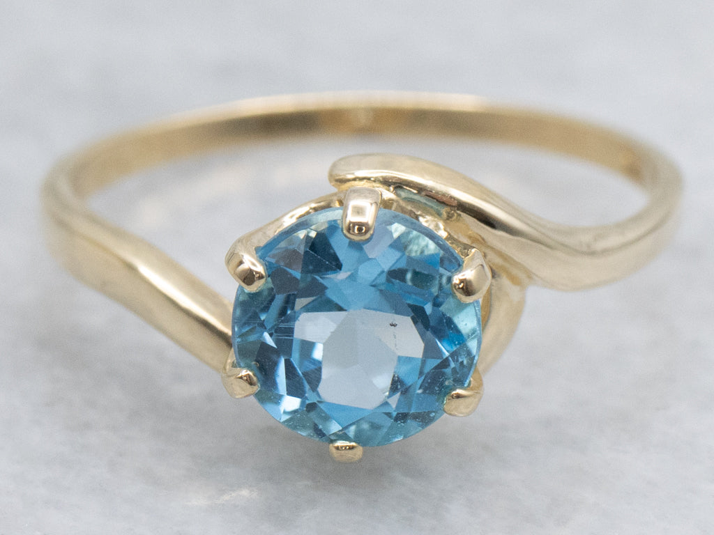 Bright Blue Topaz Yellow Gold Bypass Ring