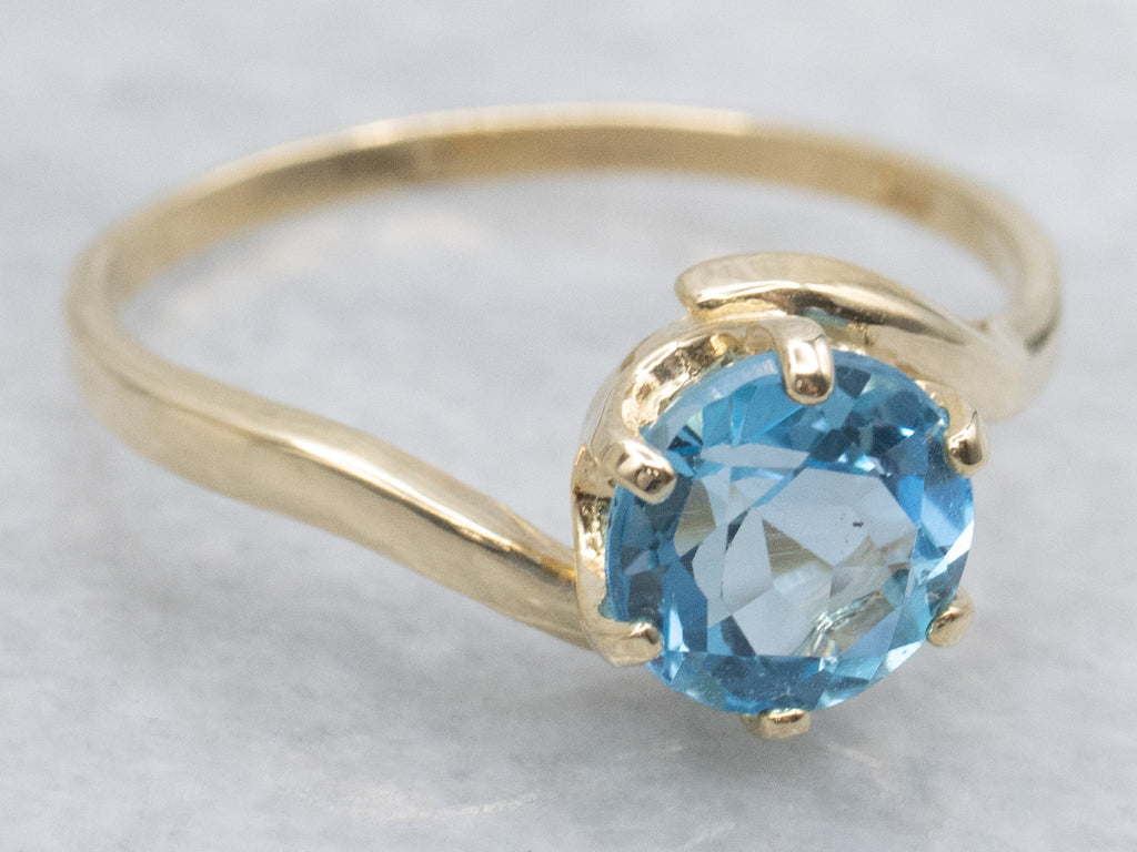 Bright Blue Topaz Yellow Gold Bypass Ring