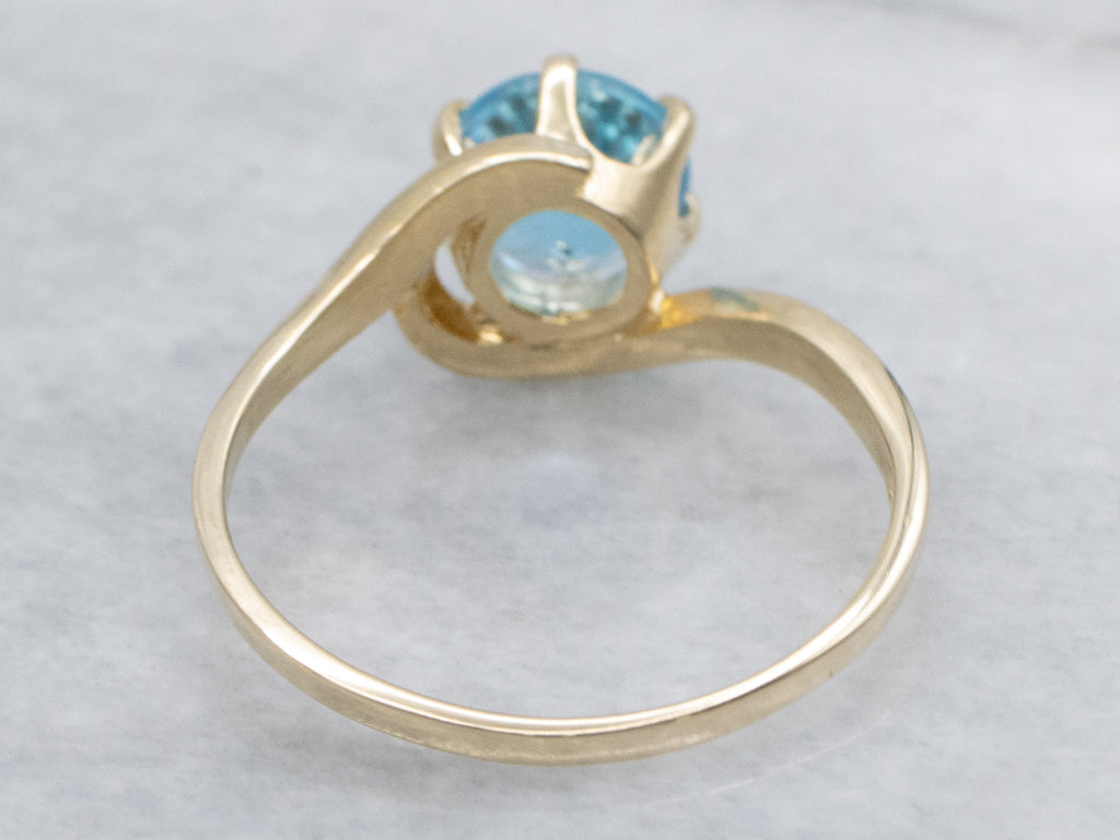 Bright Blue Topaz Yellow Gold Bypass Ring