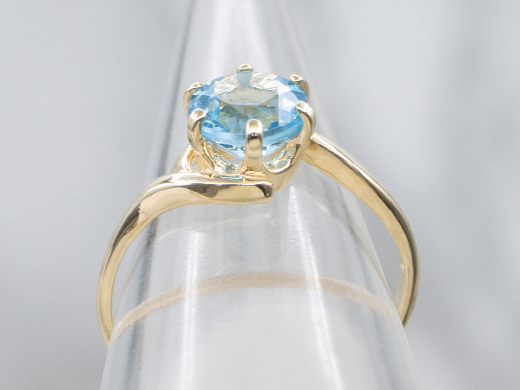 Bright Blue Topaz Yellow Gold Bypass Ring