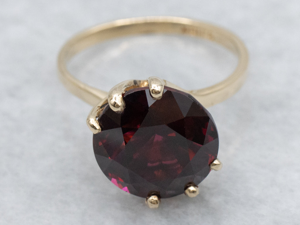 Garnet Gemstone in Twisting Yellow Gold Bypass Ring
