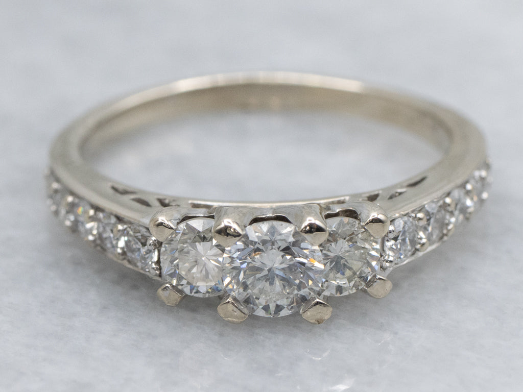 Modern Round Brilliant Three Stone Diamond Engagement Ring with Diamond Accents