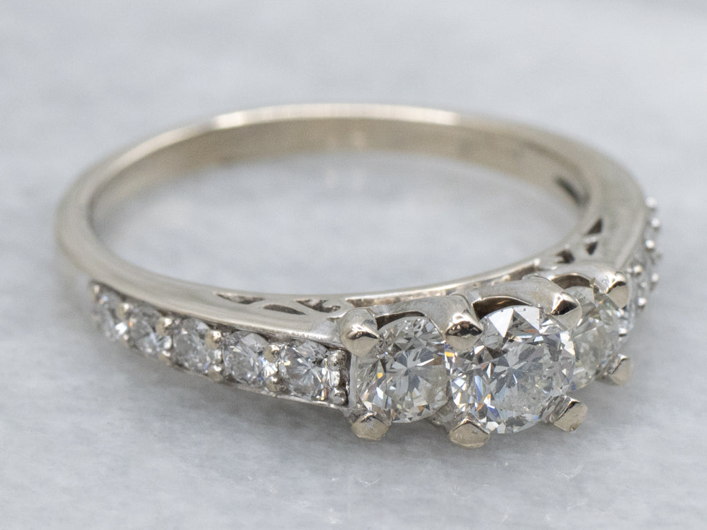 Modern Round Brilliant Three Stone Diamond Engagement Ring with Diamond Accents