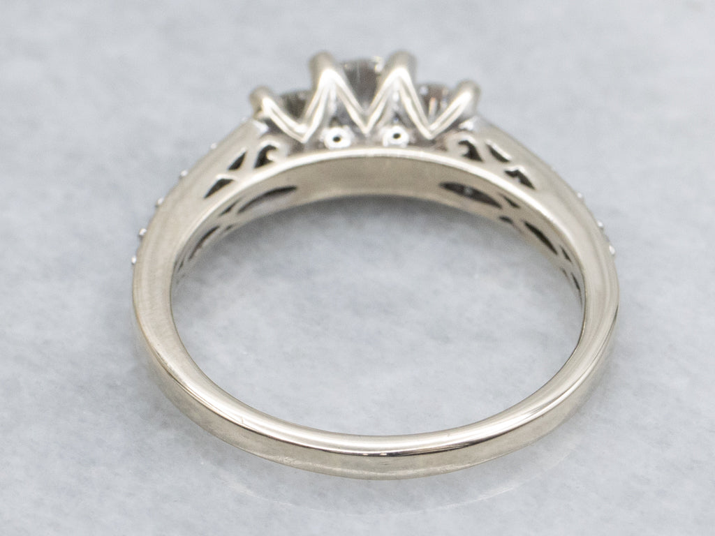 Modern Round Brilliant Three Stone Diamond Engagement Ring with Diamond Accents