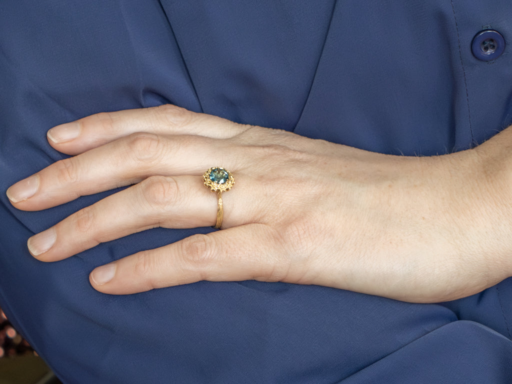 Blue Topaz Solitaire Ring in Golden Flower Halo